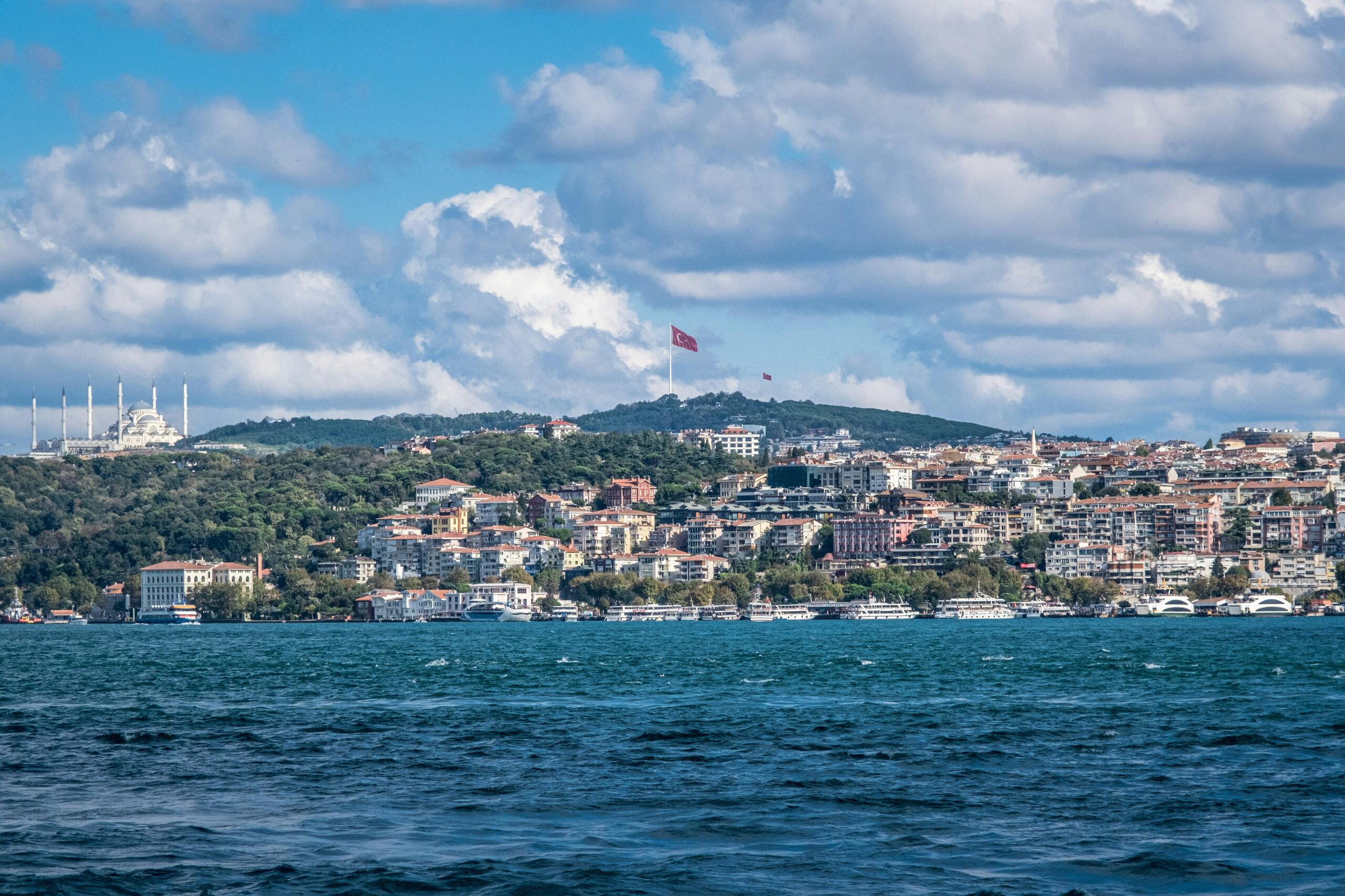 Captivating cityscape of Istanbul featuring the Turkish flag on a bright day.